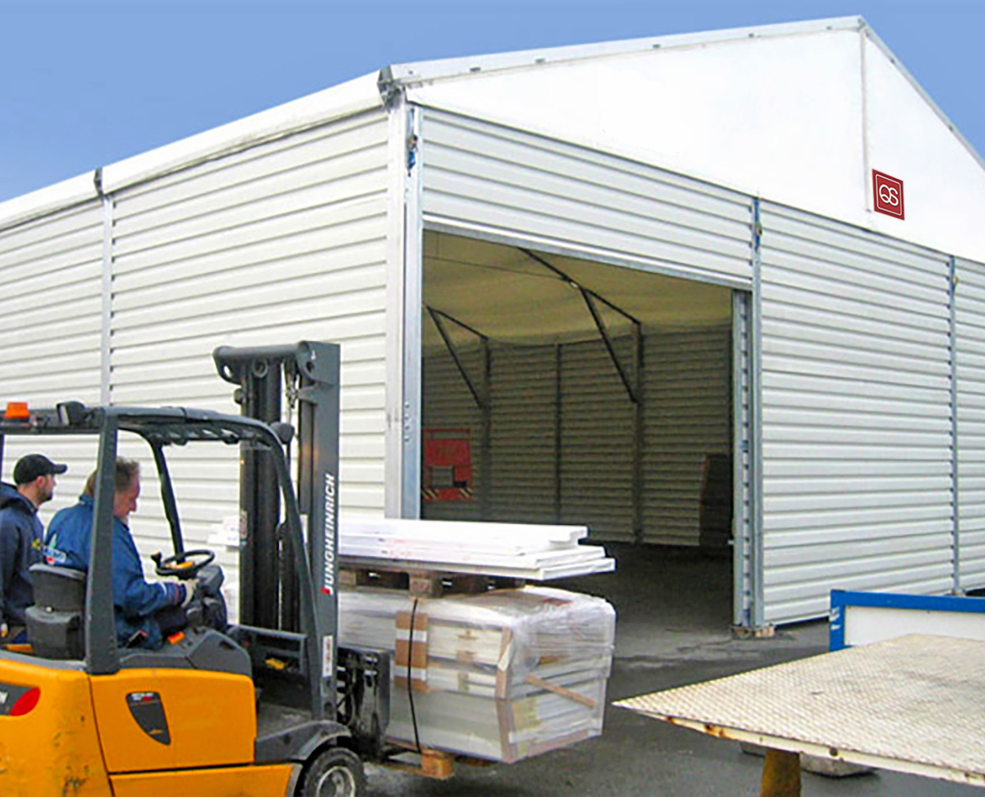 Forklift driver bringing material to temporary warehouse for storage